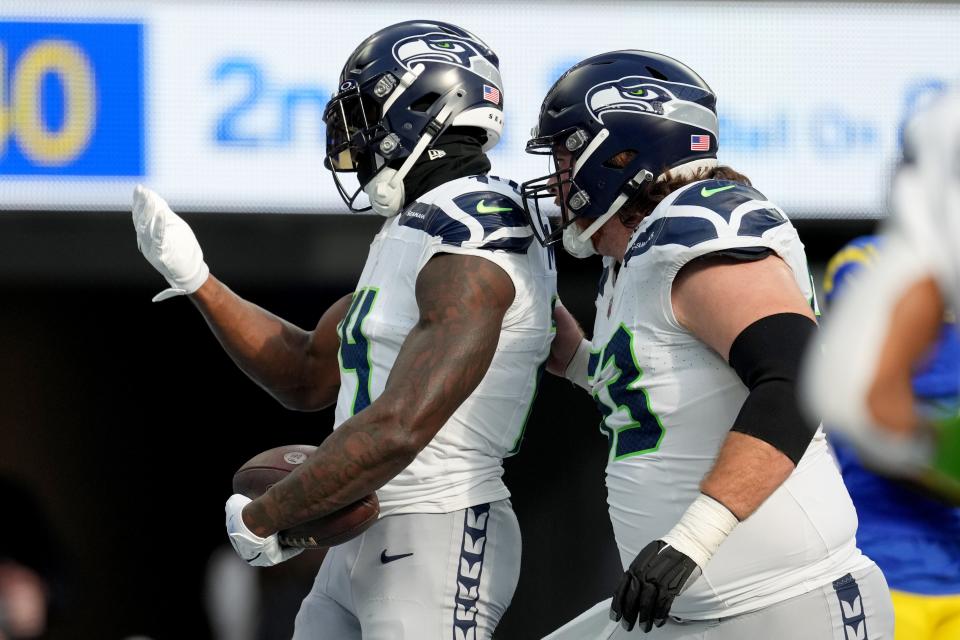 Seattle Seahawks wide receiver DK Metcalf (14) celebrates after scoring a touchdown with center Evan Brown (63) in the first quarter against the Los Angeles Rams at SoFi Stadium in Inglewood, California on Nov. 19, 2023.