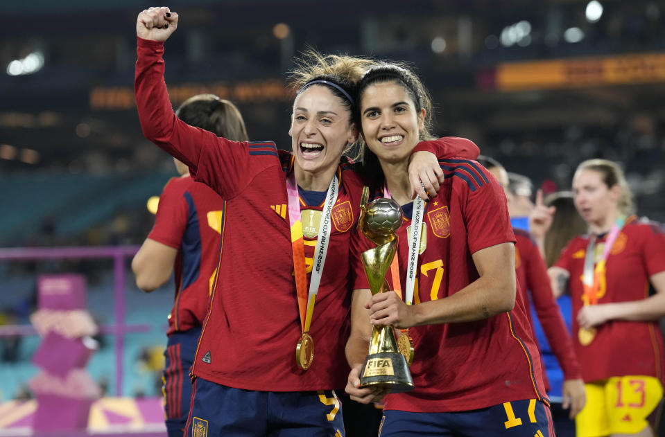 Spain's Esther Gonzalez, left, and Spain's Alba Redondo celebrate with the trophy during the awarding ceremony of the Women's World Cup soccer final at Stadium Australia in Sydney, Australia, Sunday, Aug. 20, 2023. (AP Photo/Alessandra Tarantino)