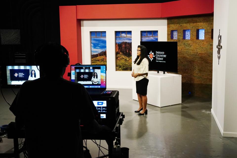 Indian Country Today executive producer and news broadcaster Patty Talahongva speaks during a news broadcast taping as video production editor Max Montour, left, operates a video equipment Friday, Sept. 10, 2021, in Phoenix. Native American communities have seen more robust news coverage in recent years, in part because of an increase in Indigenous affairs reporting positions at U.S. newsrooms and financial support from foundations. (AP Photo/Ross D. Franklin)