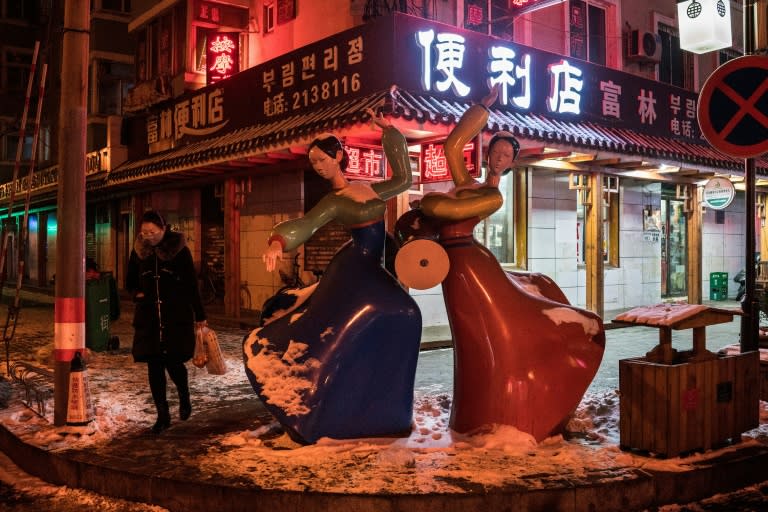 A statue of North Korean women dancing and playing drums in the market place in the border city of Dandong in China's northeast Liaoning province