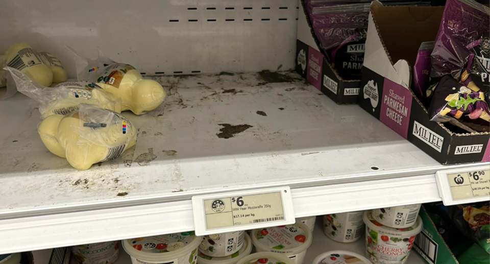 The Woolworths shelf in the cheese section had dark markings on it in the Capalaba store in Queensland. 