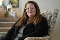 Tracey Ferguson, mother of D.J. Ferguson, sits for a photograph Wednesday, Jan. 26, 2022, at her home, in Mendon, Mass. A Boston hospital is defending itself after Ferguson's family claimed D.J. was denied a new heart for refusing to be vaccinated against COVID-19, saying most transplant programs around the country set similar requirements to improve patients' chances of survival. (AP Photo/Steven Senne)