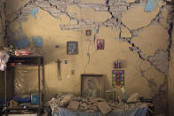 <p>An altar to the Virgin of Guadalupe is covered with fallen debris inside the earth-damaged home where Larissa Garcia, 24, lived with her family in Juchitan, Oaxaca state, Mexico, Saturday, Sept. 9, 2017. The family was caught under rubble when the house partially collapsed, leaving Garcia with a broken arm and her father with a head injury. Her mother, who had to be pulled out from underneath a foot-thick section of wall which collapsed on her back, remains in a wheelchair and unable to walk. (AP Photo/Rebecca Blackwell) </p>