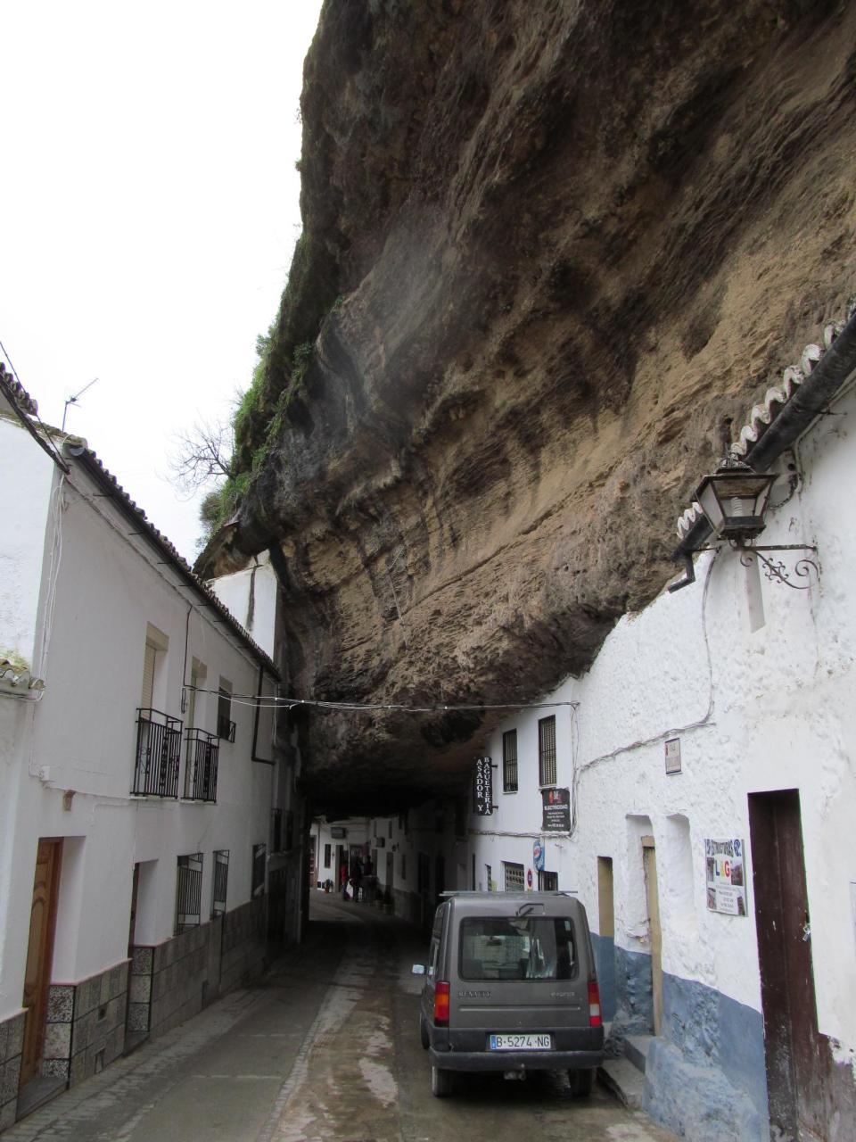 This Jan. 17, 2013 photo shows the narrow road of Setenil de las Bodegas. Many of the houses and stores in this Spanish "pueblo blanco," or white village, are carved into river-eroded rock. (AP Photo/Giovanna Dell’Orto)