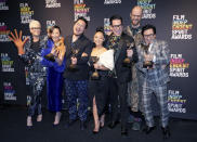 Jamie Lee Curtis, from left, wearing hot dog fingers based on a prop from the film "Everything Everywhere All at Once," Michelle Yeoh, Daniel Kwan, Stephanie Hsu, Jonathan Wang, Daniel Scheinert and Ke Huy Quan pose in the press room at the Film Independent Spirit Awards on Saturday, March 4, 2023, in Santa Monica, Calif. The cast and crew won the award for best feature for "Everything Everywhere All at Once." (Photo by Jordan Strauss/Invision/AP)