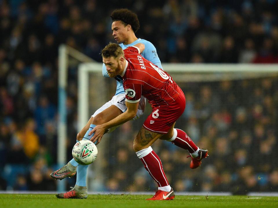 Leroy Sane battles with Bristol City defender Nathan Baker: AFP/Getty Images