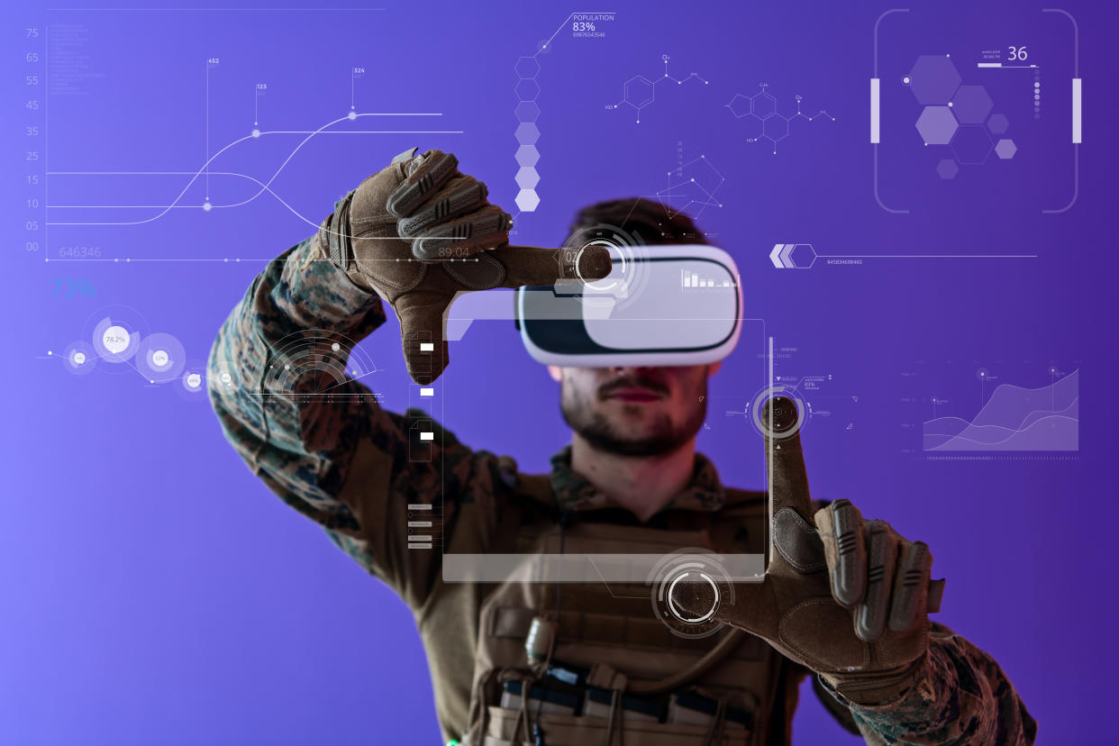 modern warfare futuristic soldier using virtual reality glasses on purple background  as concept of artificial intelligence on Hud screen display