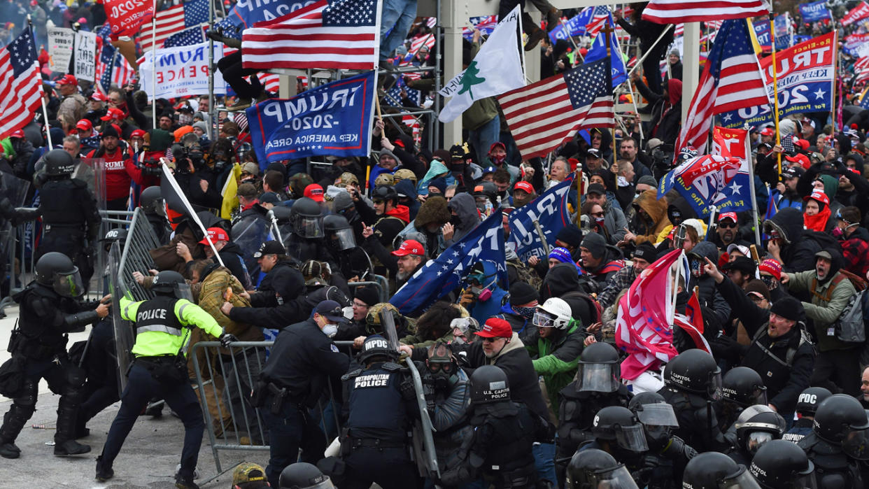 Trump supporters clash with police and security forces as they push barricades to storm the US Capitol in Washington D.C on January 6, 2021. (Roberto Schmidt/AFP via Getty Images)