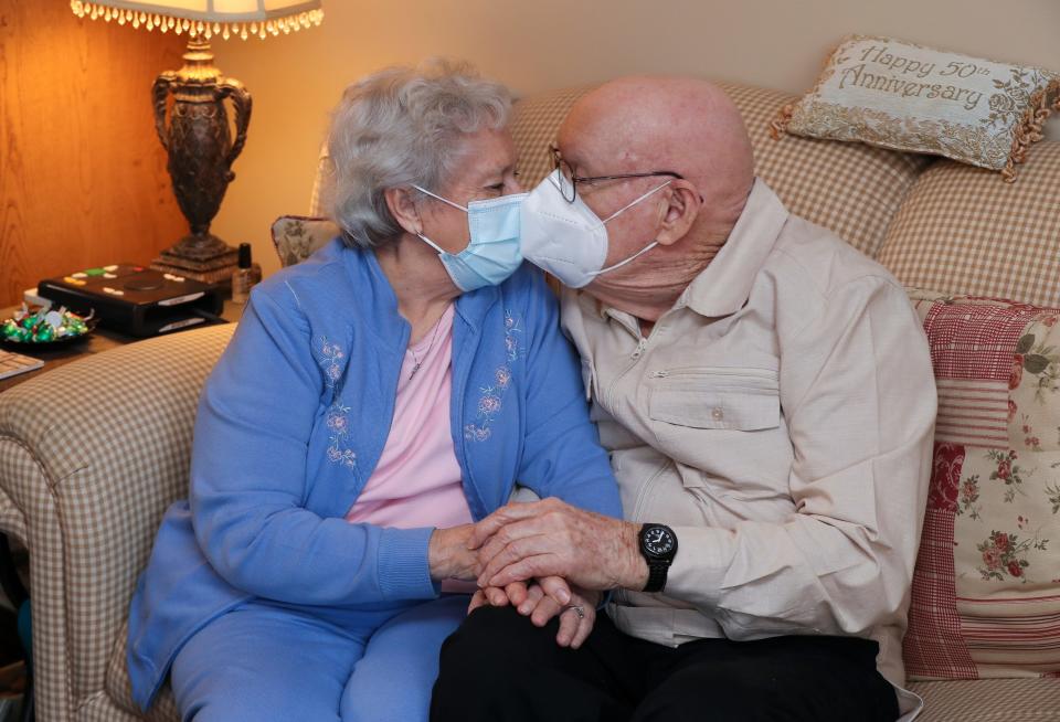 Don Hall, 88, right, and Patsy Hall, 89, gave each other a smooch through their facial masks in their senior living residence at the Chapel House in Louisville, Ky. on Jan. 21, 2021.  Don has already received his first dose of the Covid-19 vaccine and Patsy will receive her first dose soon.