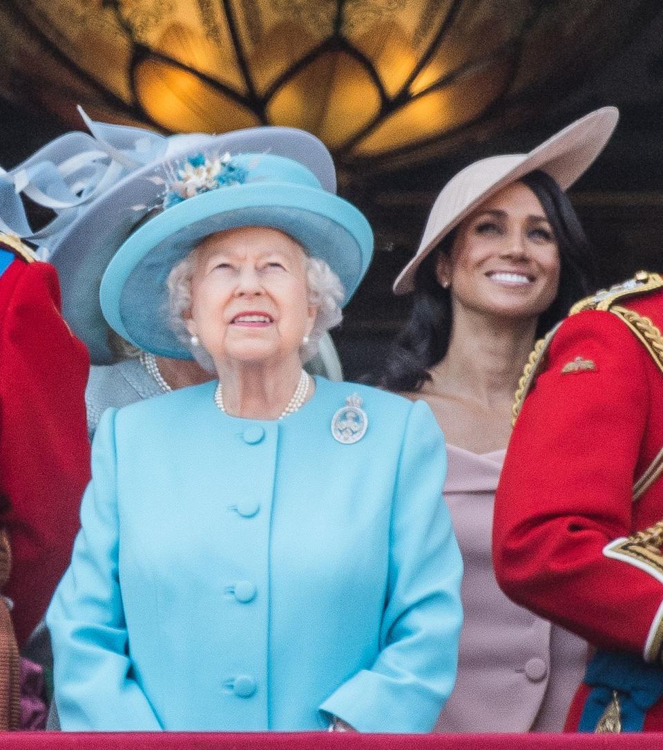 Meghan watches the fly-past by the RAF's Red Arrows, alongside Queen Elizabeth II.