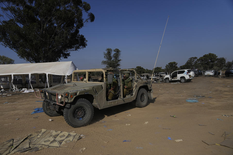 Israeli military drives through the site of a music festival near the border with the Gaza Strip in southern Israel on Thursday. Oct. 12, 2023. At least 260 Israeli festivalgoers were killed during the attack by Hamas gunmen last Saturday. (AP Photo/Ohad Zwigenberg)