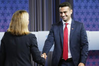 Arizona Attorney General candidates, Republican Abraham Hamadeh, right, shakes hands with Democrat Kris Mayes, prior to a televised debate, Wednesday, Sept. 28, 2022. (AP Photo/Ross D. Franklin)