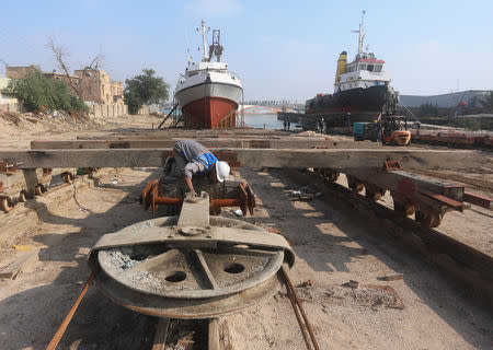 FILE PHOTO: A worker inspects a pulley that pulls ships at a shipyard built by the British Army on Basra's docks in 1916, in Basra, Iraq December 23, 2018. Picture taken December 23, 2018. REUTERS/Essam al-Sudani
