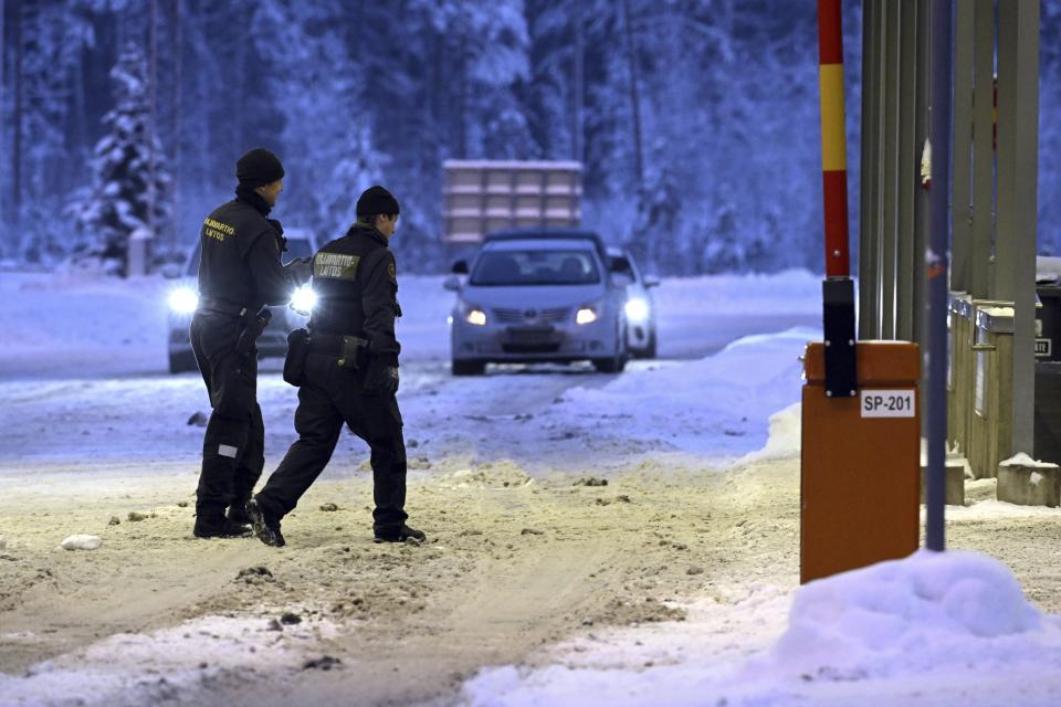 FILE - Finnish border guards walk at Vaalimaa border check point between Finland and Russia in Virolahti, Finland, on Dec. 15, 2023. Finland will extend the closure of its border crossing points with Russia beyond the current April 14 deadline “until further notice” due to a high risk of organized migration orchestrated by Moscow, the Finnish government said on Thursday, April 4, 2024. (Heikki Saukkomaa/Lehtikuva via AP)