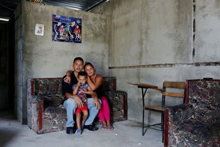 Oleydy Canizalez, 29, poses for a picture with her husband Julio Espinoza, 28, and her son Luis, 3, before her sterilization surgery, at their home in Charallave, Venezuela July 7, 2016. REUTERS/Carlos Garcia Rawlins