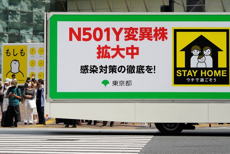 An advertisement truck, operated by Tokyo Metropolitan Government office, displaying messages that warns against the spread of the N501Y mutant COVID-19 strain, drives on the street in Tokyo