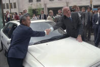 FILE - Britain's Trade Secretary Lord Young shakes hands with Shoichiro Toyoda, then president of Toyota Motors, right, over the hood of a Toyota car in London Tuesday, April 18, 1989. Toyoda, who as a son of the company's founder oversaw Toyota's expansion into international markets has died. He was 97. (AP Photo/Dave Caulkin, File)