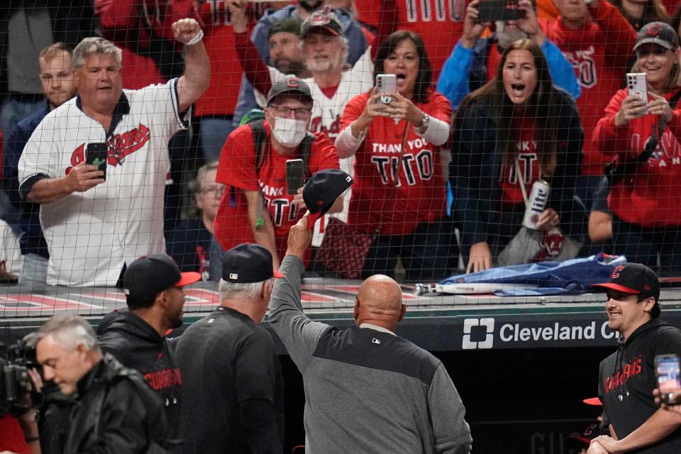 Guardians manager Terry Francona, center, waves his cap to fans Wednesday after a win over the Cincinnati Reds in Cleveland.