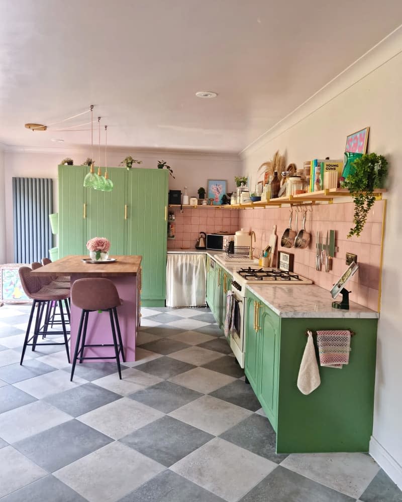 Newly remodeled pink and green kitchen with charcoal and white checkered tiles.