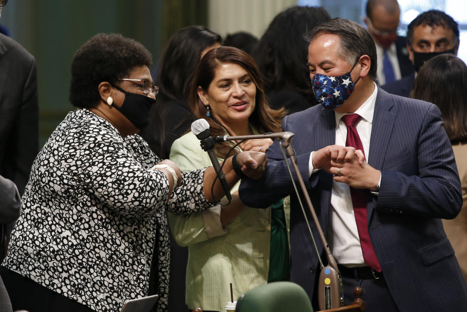 FILE - In this June 10, 2020, file photo, Assemblywoman Shirley Weber, D-San Diego, left, receives congratulations from fellow Assembly members Sharon Quirk-Silva, D-Fullerton, center, and Phil Ting, D-San Francisco, after the Assembly approved her measure to place a constitutional amendment on the ballot to let voters decide if the state should overturn its ban on affirmative action programs, at the Capitol in Sacramento, Calif. The killing of George Floyd has sparked broader discussions of race and discrimination in state legislatures across the country. Affirmative action, reparations and designating racism as a public health crisis are generating debate and a fair amount of controversy. (AP Photo/Rich Pedroncelli, File)