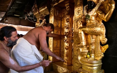 A priest closes the doors of sanctum sanctorum after two women entered the Sabarimala temple - Credit: REUTERS/Stringer