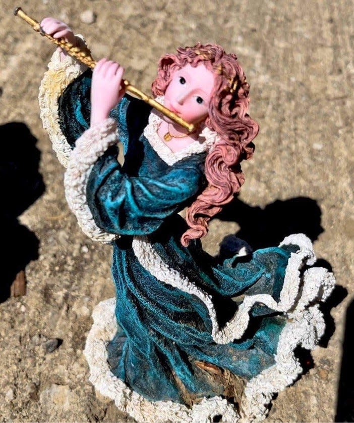 A discarded decoration near a dumpster at Cedar Hill Cemetery, according to cemetery critics.