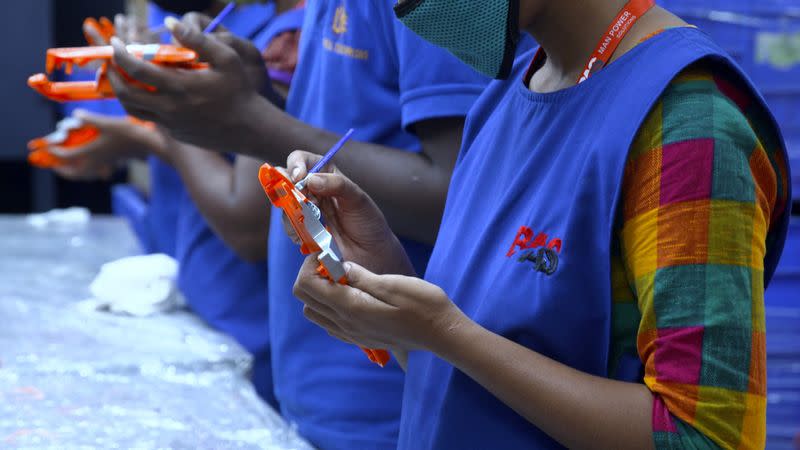 An undated handout photo of workers at the Aequs toy manufacturing facility in Belgaum