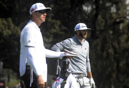 February 19, 2017; Pacific Palisades, CA, USA; Dustin Johnson with caddie Austin Johnson before hitting on the third hole fairway during the final round of the Genesis Open golf tournament at Riviera Country Club. Mandatory Credit: Gary A. Vasquez-USA TODAY Sports