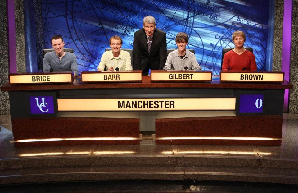 Paxman with a team of student contestants (PA)