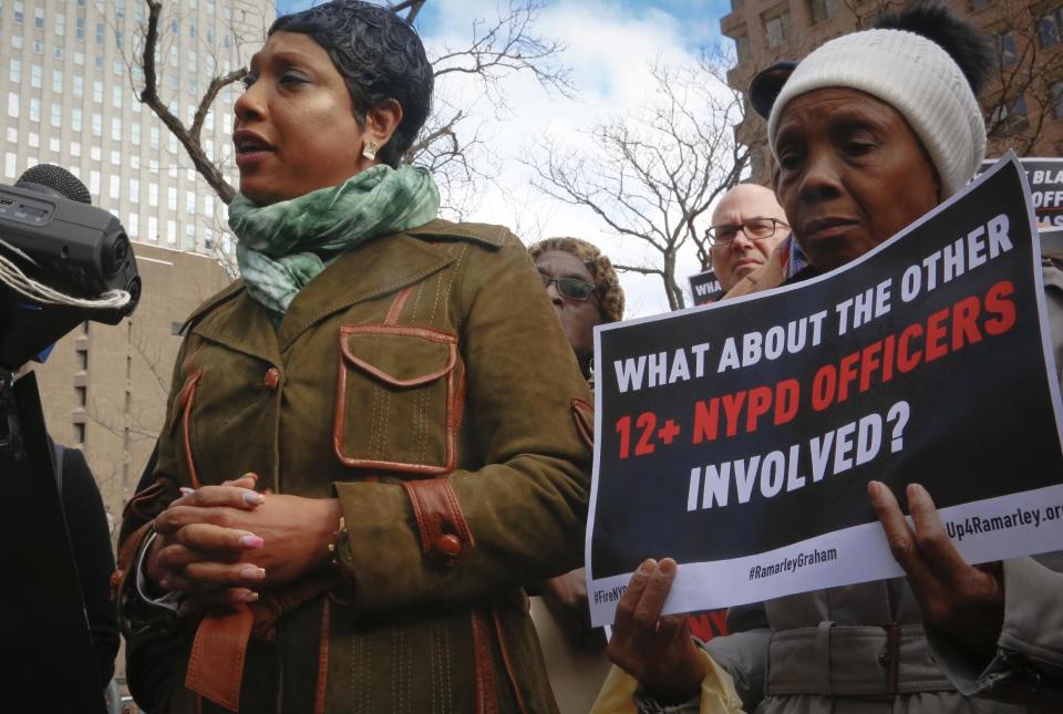 Constance Malcolm, left, mother of Ramarley Graham, speaks as mother Patricia Hartley, right, holds a sign during a press conference outside police headquarters, Thursday Jan. 19, 2017, in New York. A disciplinary trial is underway for NYPD officer Richard Haste, who shot and killed the unarmed 18-year-old Graham in the bathroom of his New York City apartment. (AP Photo/Bebeto Matthews)