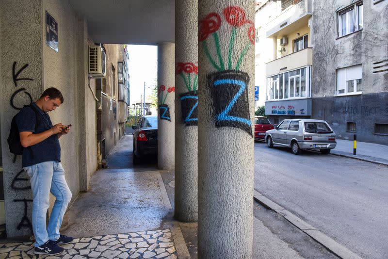 A person stands next to a letter Z, which has become a symbol of the Russian military, in Belgrade