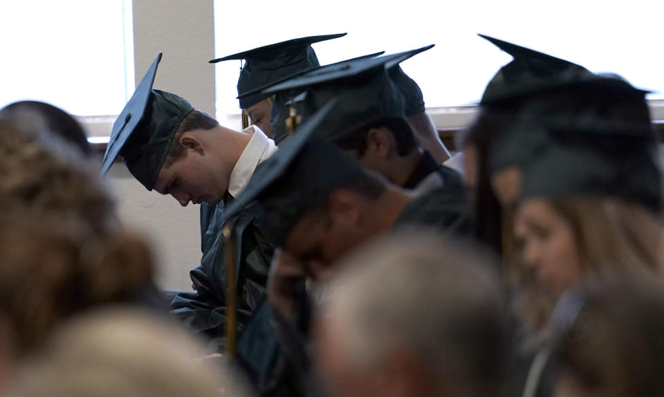 <p>Santa Fe High School graduates bow their heads in prayer during a Baccalaureate service Sunday, May 20, 2018, in Santa Fe, Texas. (Photo: David J. Phillip/AP) </p>