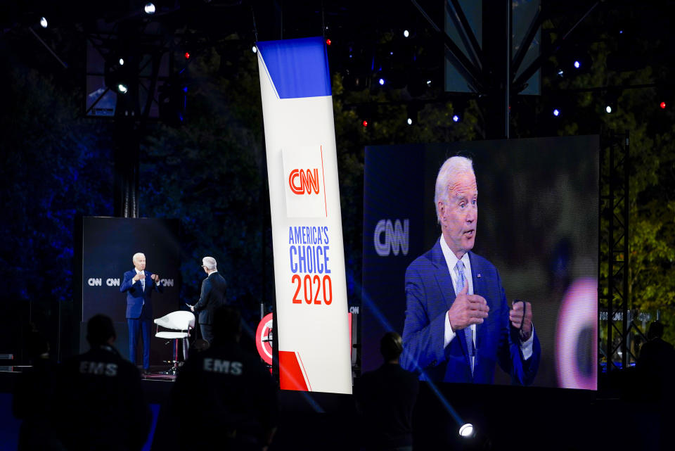 Democratic presidential candidate former Vice President Joe Biden, left, participates in a CNN drive-in town hall moderated by Anderson Cooper in Moosic, Pa., Thursday, Sept. 17, 2020. At right Biden's image is projected onto a video monitor. (AP Photo/Carolyn Kaster)