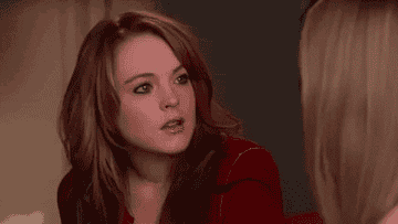 A GIF of Cady from Mean Girls nodding and smiling, looking somewhat confused