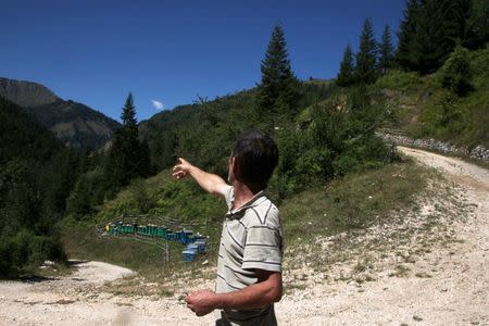 Ramiz Selimaj, 53, points in the directon of the border with Montenegro, in the village of Haxhaj, Kosovo, August 28, 2016. REUTERS/Hazir Reka