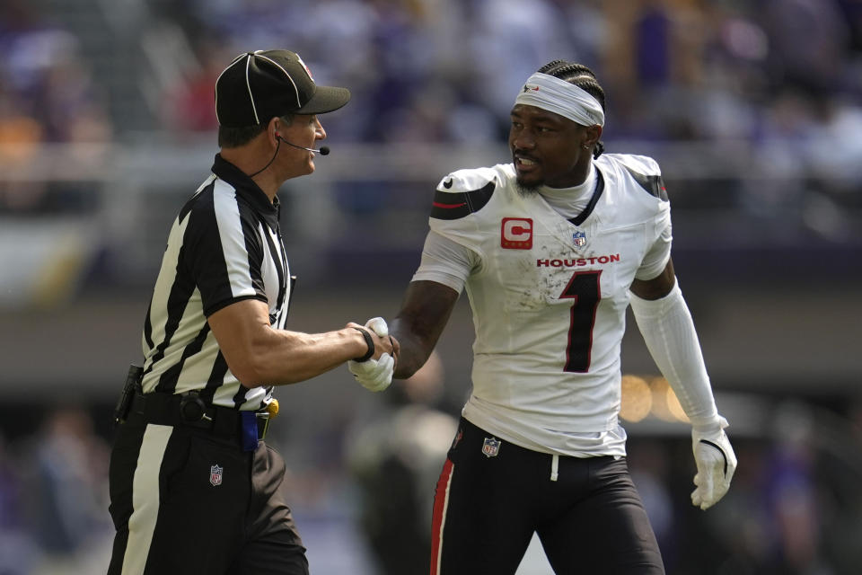 Houston Texans wide receiver Stefon Diggs (1) talks with an official while walking to the locker room at halftime of an NFL football game against the Minnesota Vikings, Sunday, Sept. 22, 2024, in Minneapolis. (AP Photo/Abbie Parr)