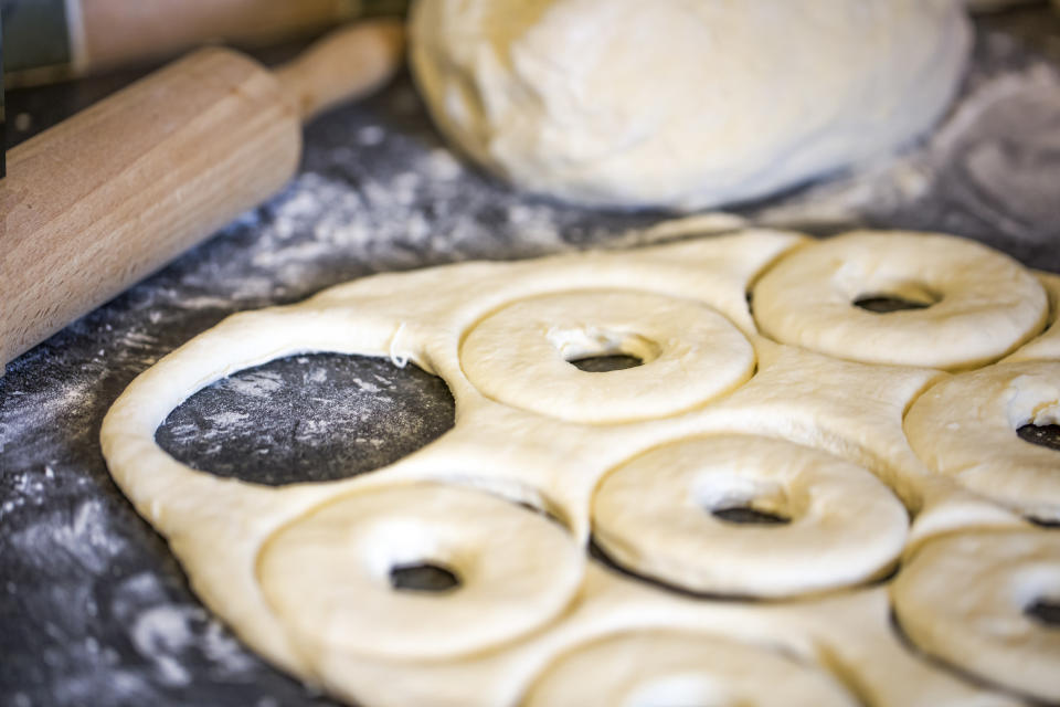 Making homemade donuts out of dough.