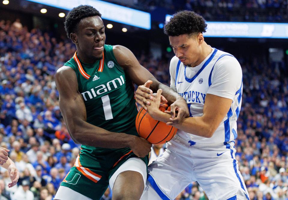 Nov 28, 2023; Lexington, Kentucky, USA; Miami (Fl) Hurricanes center Michael Nwoko (1) and Kentucky Wildcats forward Tre Mitchell (4) fight for possession during the first half at Rupp Arena at Central Bank Center. Mandatory Credit: Jordan Prather-USA TODAY Sports