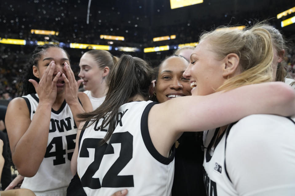 Iowa guard Caitlin Clark (22), center, celebrates with teammates after the overtime win against Nebraska of NCAA college basketball game in the final of the Big Ten women's tournament Sunday, March 10, 2024, in Minneapolis. (AP Photo/Abbie Parr)