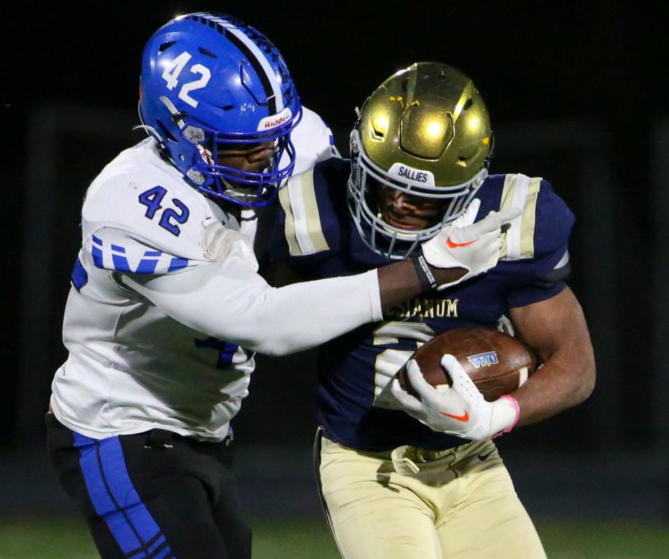 Middletown's Tristen Graham (42) grabs Salesianum's B.J. Alleyne for a tackle in the fourth quarter of Salesianum's 24-14 win in a DIAA Class 3A state tournament semifinal at Abessinio Stadium, Friday, Nov. 24, 2023.