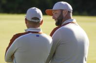 Team Europe's Jon Rahm talks to Team Europe's Sergio Garcia on the ninth hole during a foursomes match the Ryder Cup at the Whistling Straits Golf Course Saturday, Sept. 25, 2021, in Sheboygan, Wis. (AP Photo/Charlie Neibergall)