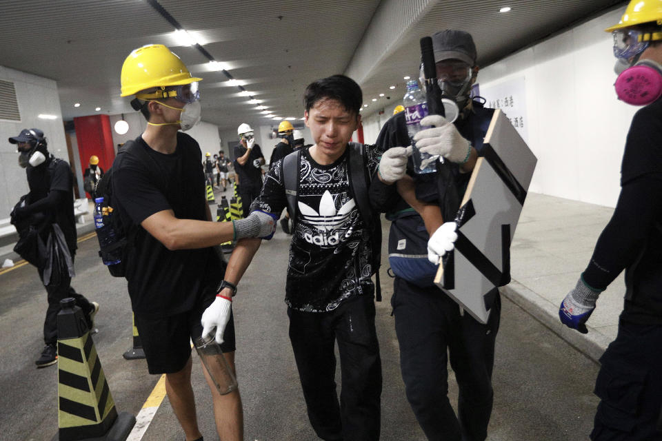 A protester reacts in pain from tear gas fired by policemen on a street in Hong Kong, Sunday, July 21, 2019. (Photo: Bobby Yip/AP)