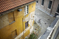 A man rides a bicycle past a yard at the Cavallerizza Reale building, which is occupied by the "Assemblea Cavallerizza 14:45" movement in Turin, Italy, July 22, 2016. REUTERS/Marco Bello