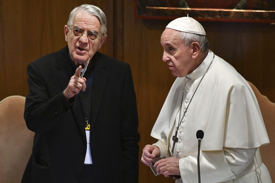 Pope Francis speaks with Rev. Federico Lombardi, left, the former Vatican spokesman who is moderating the summit, at the opening of a sex abuse prevention summit, at the Vatican, Thursday, Feb. 21, 2019. The gathering of church leaders from around the globe is taking place amid intense scrutiny of the Catholic Church's record after new allegations of abuse and cover-up last year sparked a credibility crisis for the hierarchy. (Vincenzo Pinto/Pool Photo via AP)