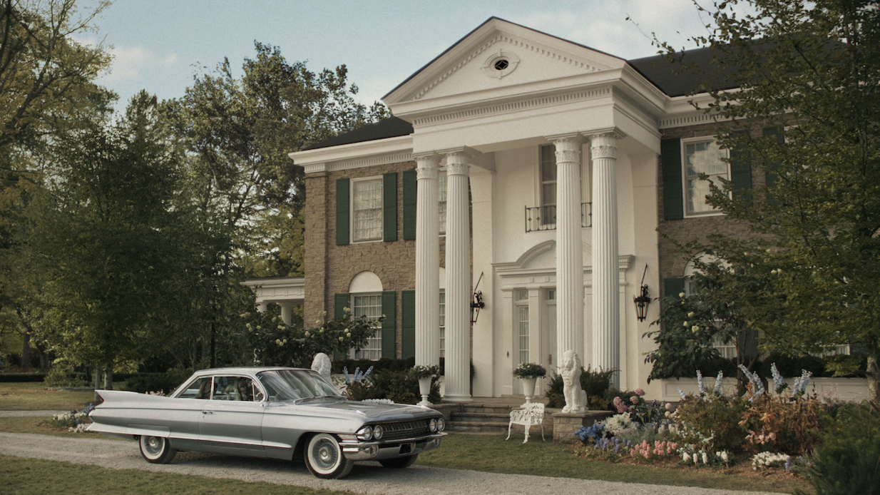 a car parked in front of a white building with columns