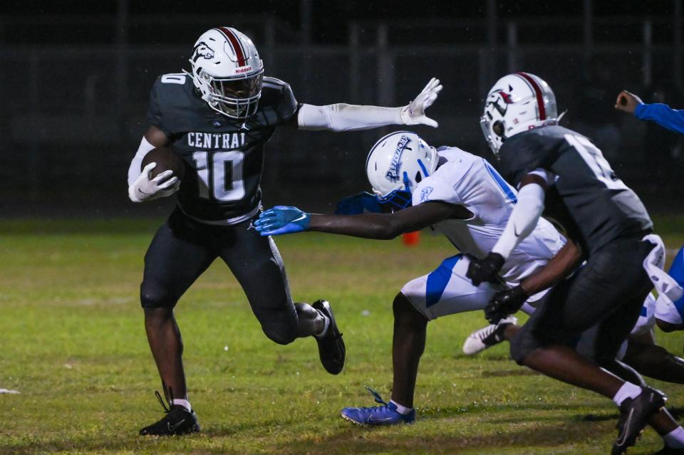 Palm Beach Central wide receiver Justin Bostic (10) attempts to stiff-arm Pahokee linebacker Buay Boldin (0) as Palm Beach Central defensive back Trevonne Williams (12) looks on during the football game between Pahokee and host Palm Beach Central on Friday, September 16, 2022, in Wellington, FL. Final score, Pahokee, 34, Palm Beach Central, 14.