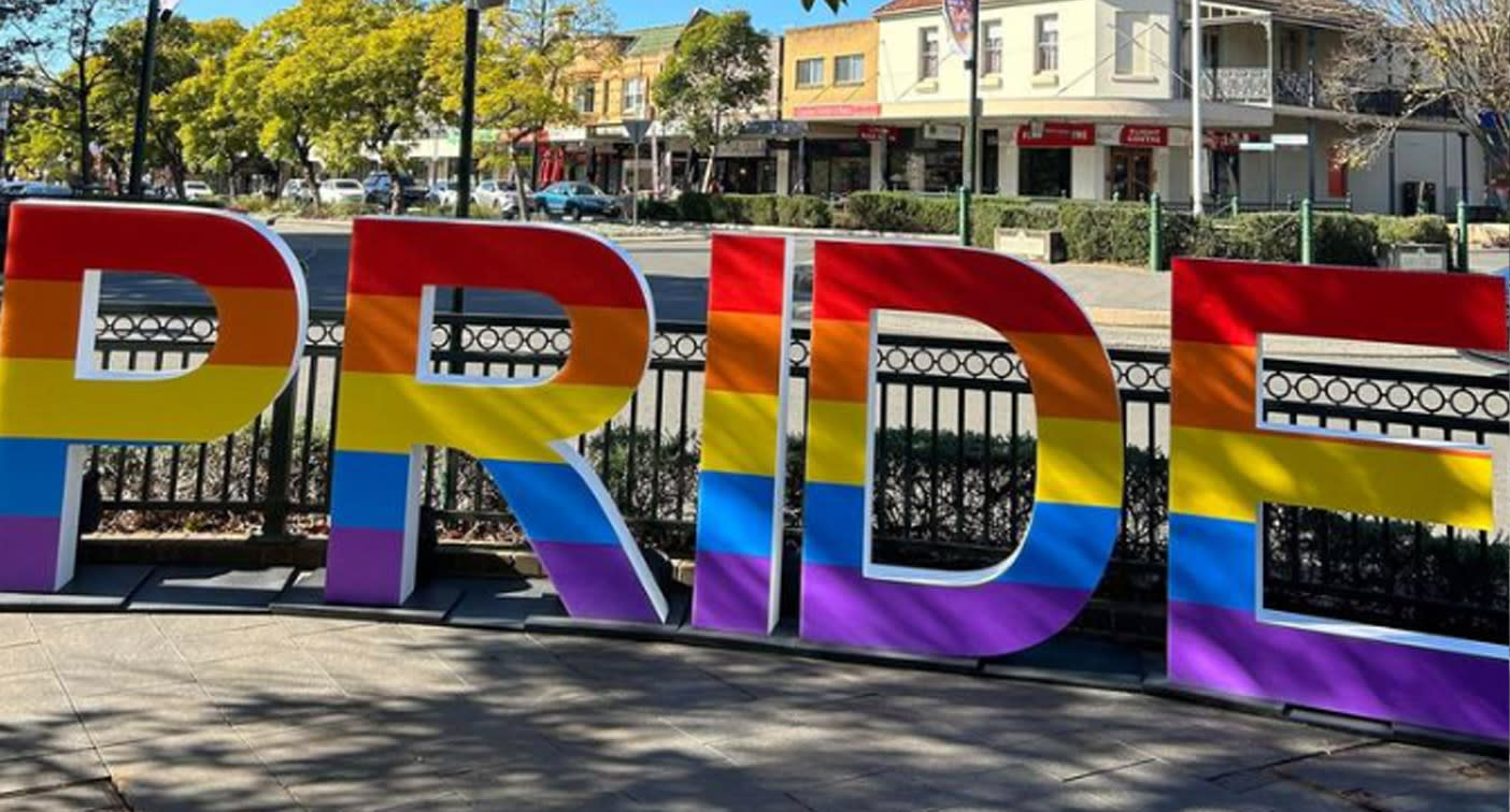 The rainbow-coloured Pride sign can be seen in tact on the pavement. 