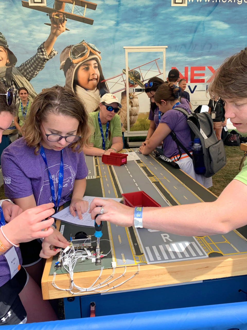 Girls at NextGen Workshop learning about how follow schematic to wire avionics for airplanes. (Brenda Lea / EAA Girlventure Camp)