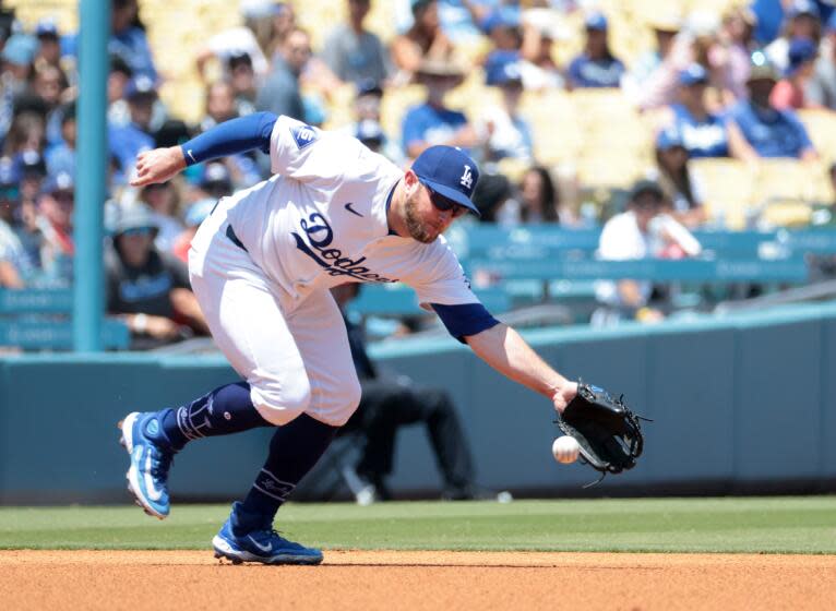 LOS ANGELES, CA MAY 8, 2024 - Dodgers third baseman Max Muncy fields the ball but is too late to throw out Marlins batter Jake Burger for a base hit in the fourth inning of the Los Angeles Dodgers baseball game against the Miami Marlins Wednesday, May 8, 2024, in Los Angeles. (Wally Skalij / Los Angeles Times)