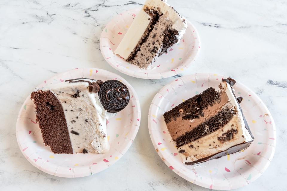 three slices of ice cream cake on ap late on a white counter